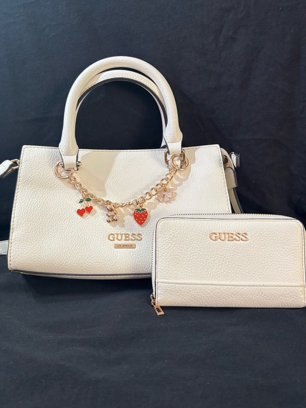 GUESS White Pebbled Satchel with Gold Charm Chain and Red Accents